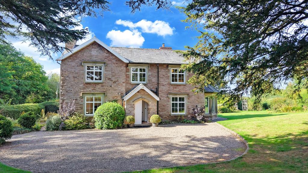 a large brick house with a driveway at Blackway House in Canon Frome