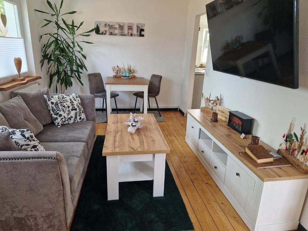 a living room with a couch and a table at Pension Fiete Celle in Celle