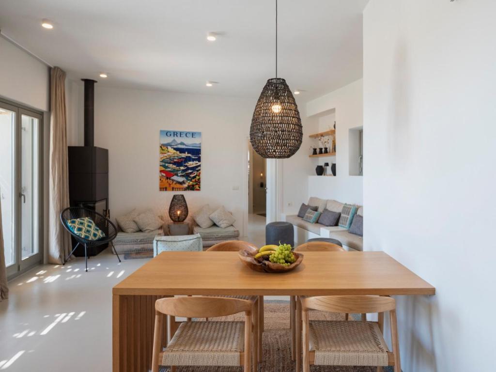 a dining room and living room with a table and chairs at Villa Ena - Beach getaway in Logaras