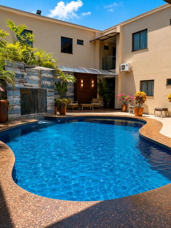 a swimming pool in the middle of a house at Maximus Business by - Easy Hotéis in Ji-Paraná