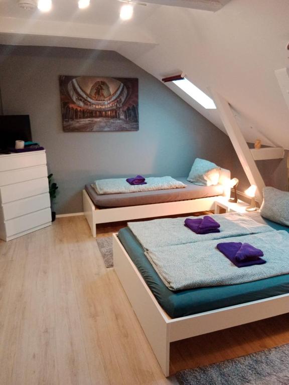 two beds in a room with a attic at FördeFlats in Flensburg