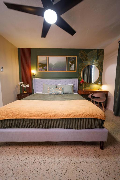 a bedroom with a large bed with a ceiling at 6BR Beachfront Compound w-Generator & Games in Camuy