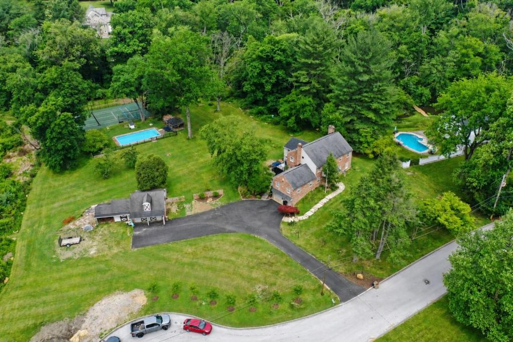 an aerial view of a house with a yard at 4 BR Suburban Escape - Pool, Tennis, Trails, Gym in Newtown Square