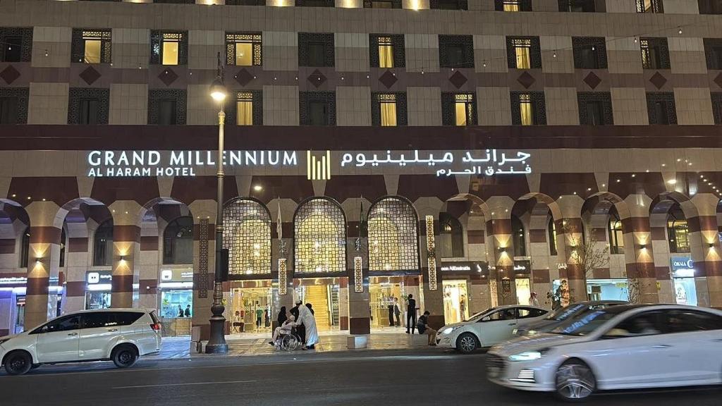 a large building with cars parked in front of it at Grand Millennium Al Haram Hotel in Medina