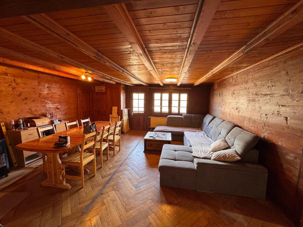 a living room with a couch and a table at Appartement Grande Dixence - Hérémence in Hérémence