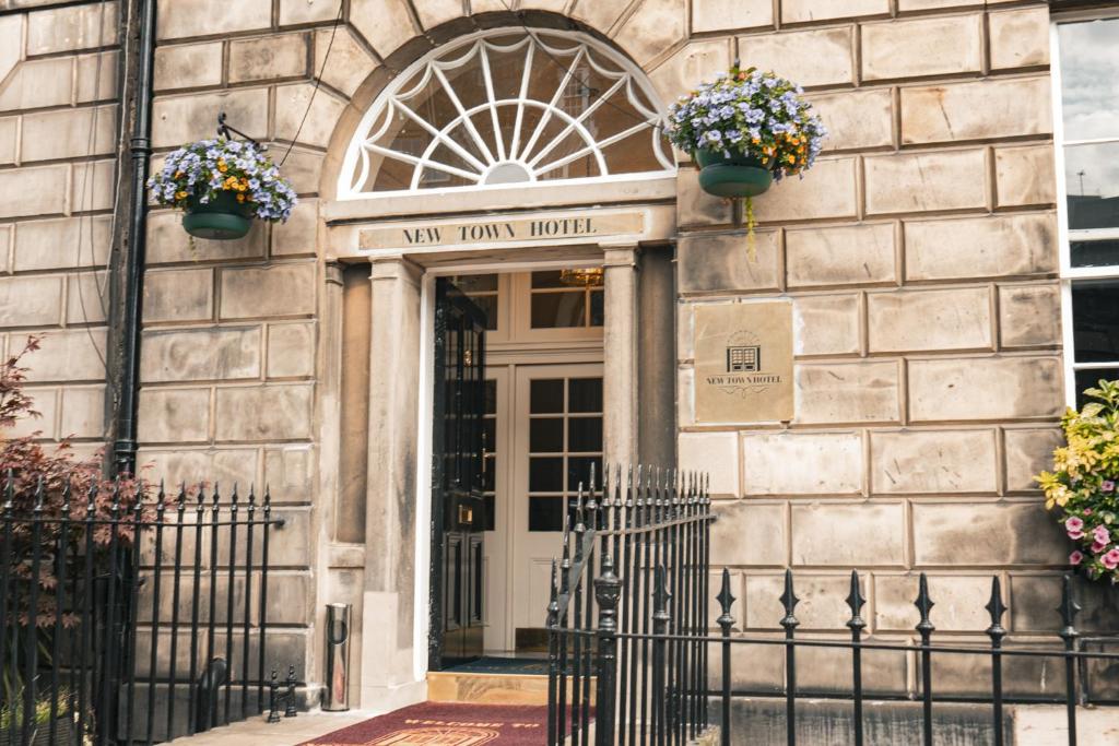 a front door of a building with flower pots on it at New Town Hotel in Edinburgh