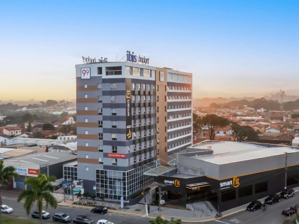 a tall building with a clock on top of it at ibis budget Pindamonhangaba in Pindamonhangaba