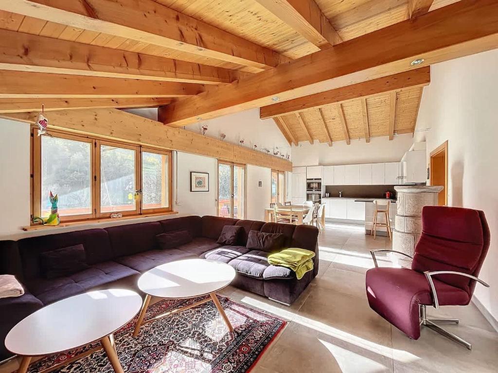 a living room with a couch and a table at L Eau Vive Combles in Le Châble
