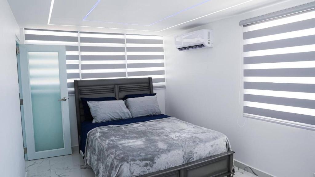 a bedroom with a bed in a white room at Bright & Comfortable 2BR San Juan Getaway in San Juan