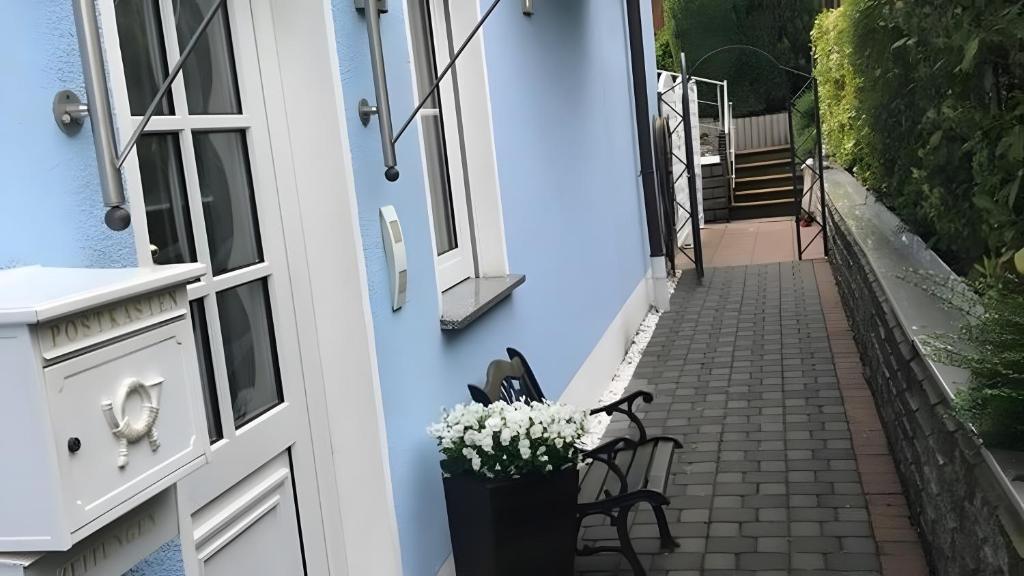a door to a house with flowers in a vase at Blue-House Mosel in Piesport