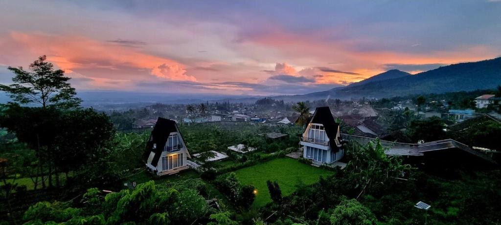 a house sitting on top of a lush green field at Edy's Farm Cottage in Jabon