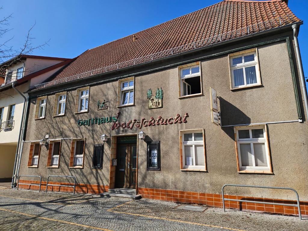 a building with a sign on the side of it at Gasthaus Wolfsschlucht in Herzberg