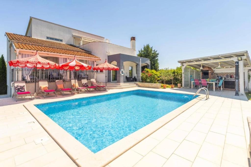 a swimming pool in the backyard of a house at Villa Bella by Villa Plus in Svetvinčenat