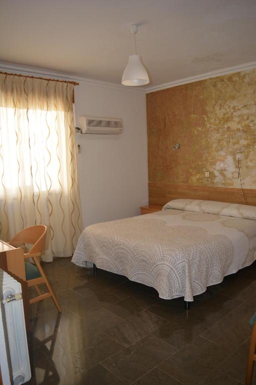 Postel nebo postele na pokoji v ubytování Hostal Manolete