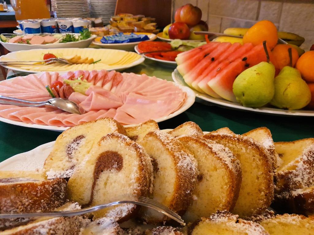 a table topped with plates of bread and fruit at Penzion Martin in Janske Lazne