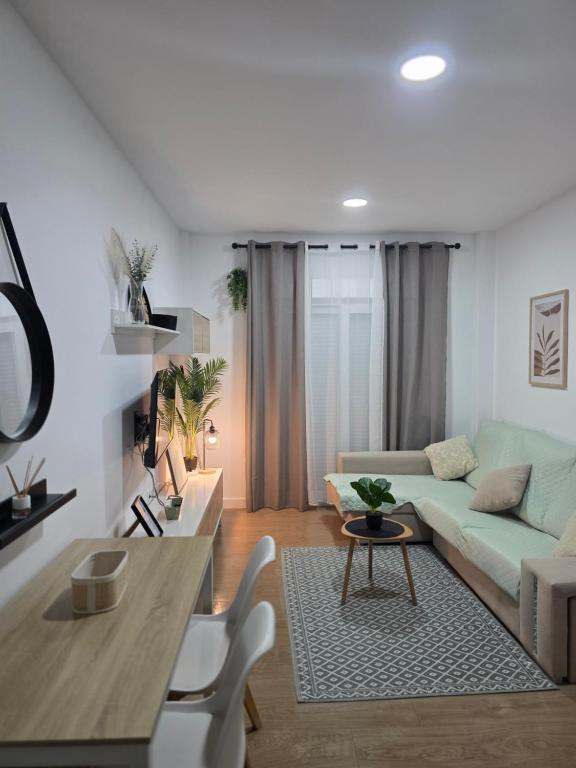 a living room with a couch and a table at Bright Apartment AM in Bollullos par del Condado