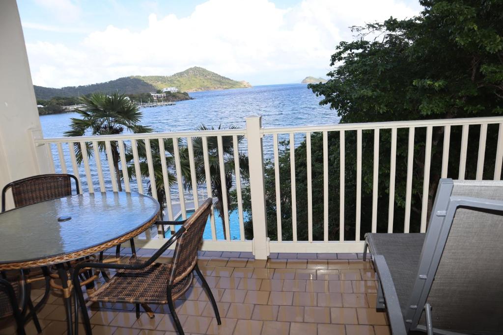a balcony with a table and chairs and the ocean at Point Pleasant Resort® 1BR Suite with Ocean Views in Nazareth