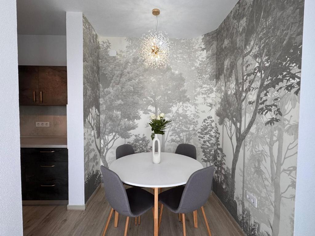 a dining room with a white table and chairs at AT Modern Boutique in Bucharest
