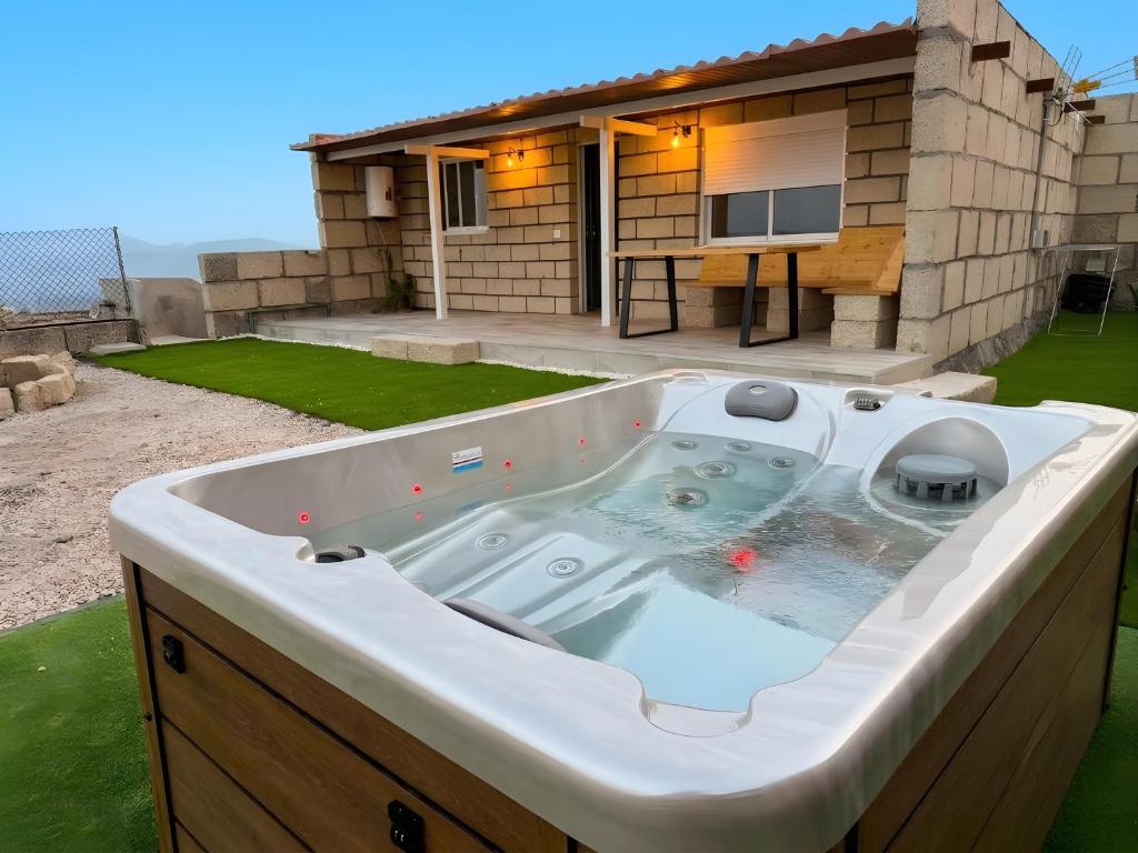 a hot tub in front of a house at Finca Domingo in Fasnia