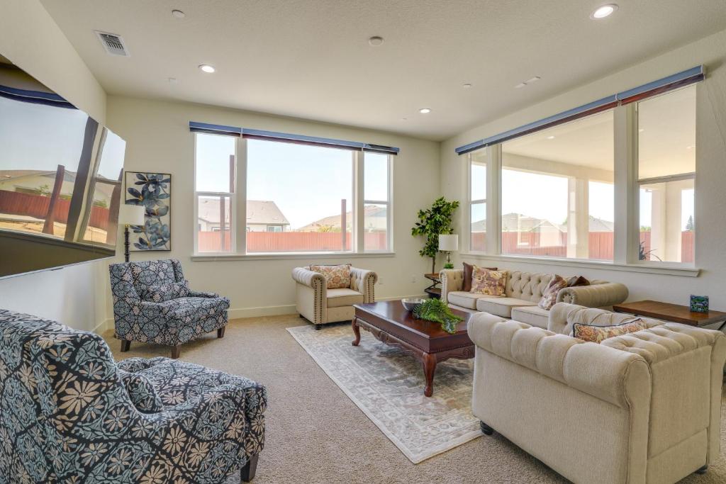 a living room with couches and chairs and windows at Private Yard & Patio! Modern Manteca Gem in Manteca