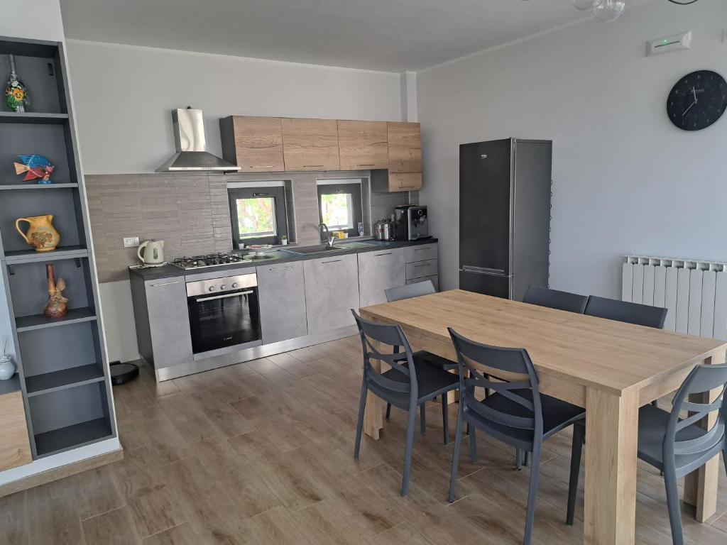 a kitchen with a wooden table and chairs at "O Funnucu Baruni" in Giarre