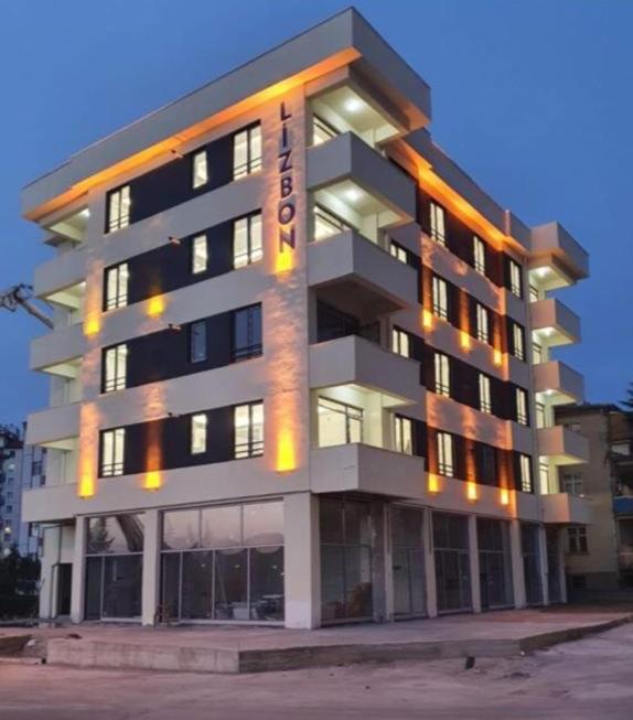 a large building with lights on the side of it at lizbon suit in Talas