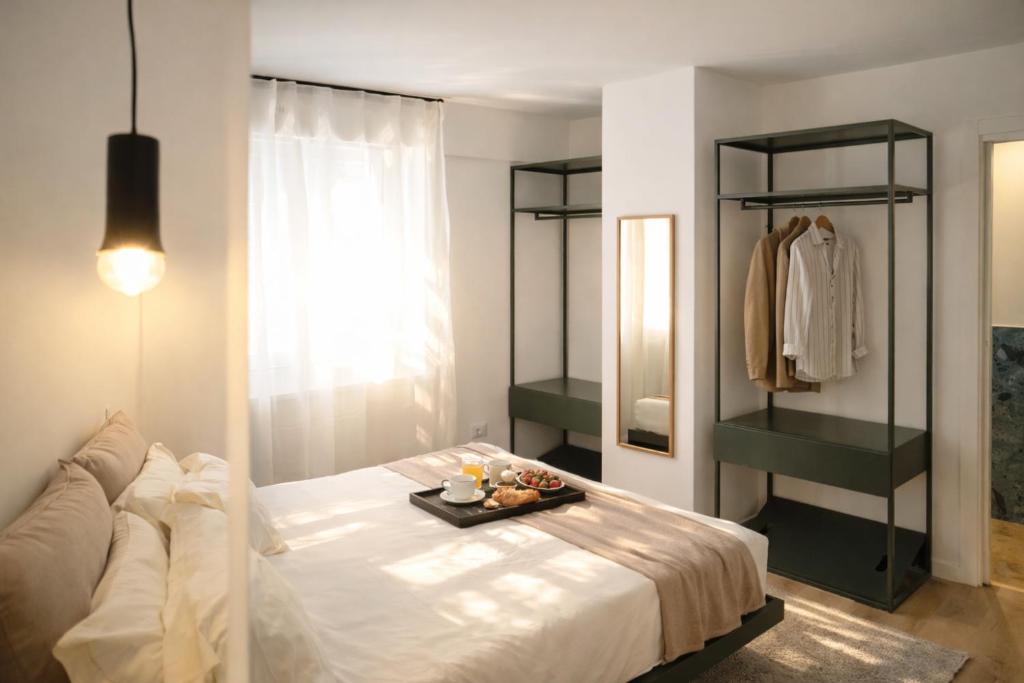 a bedroom with a bed with a tray of food on it at Residenza Ximenes in Palermo
