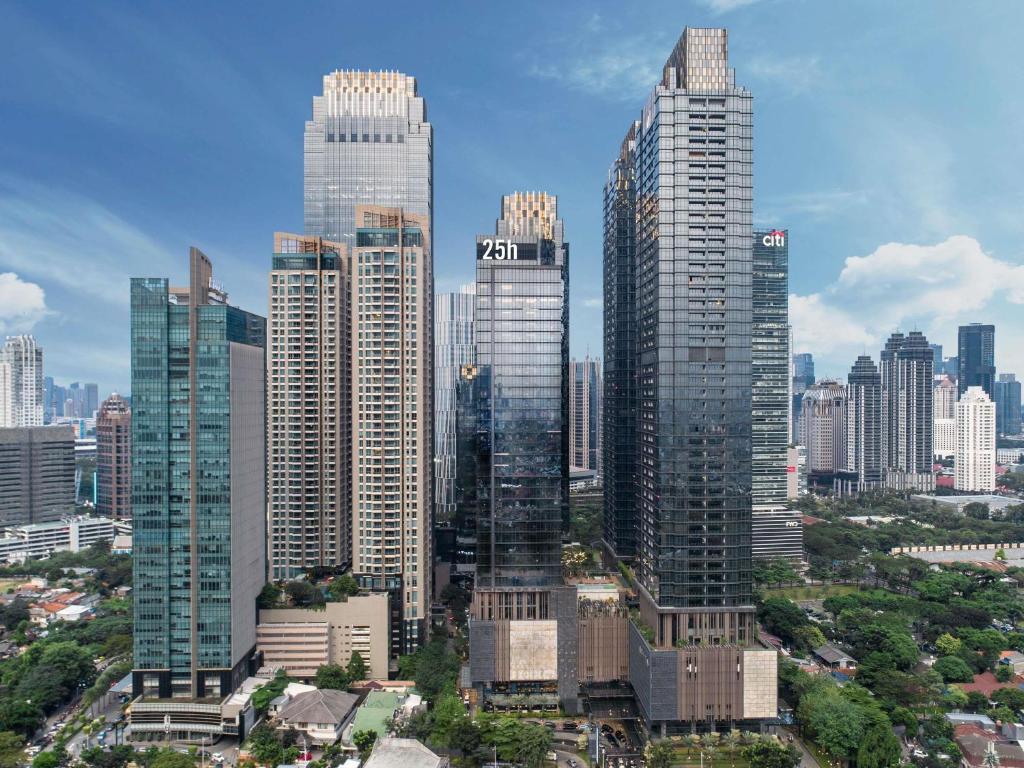 a group of tall buildings in a city at 25hours Hotel Jakarta The Oddbird in Jakarta