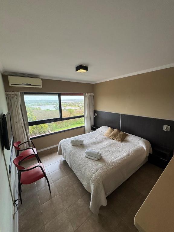 a bedroom with a large bed and a window at Río Victoria in Victoria