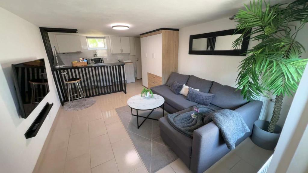 a living room with a couch and a table at Lk Apartments in Halmstad