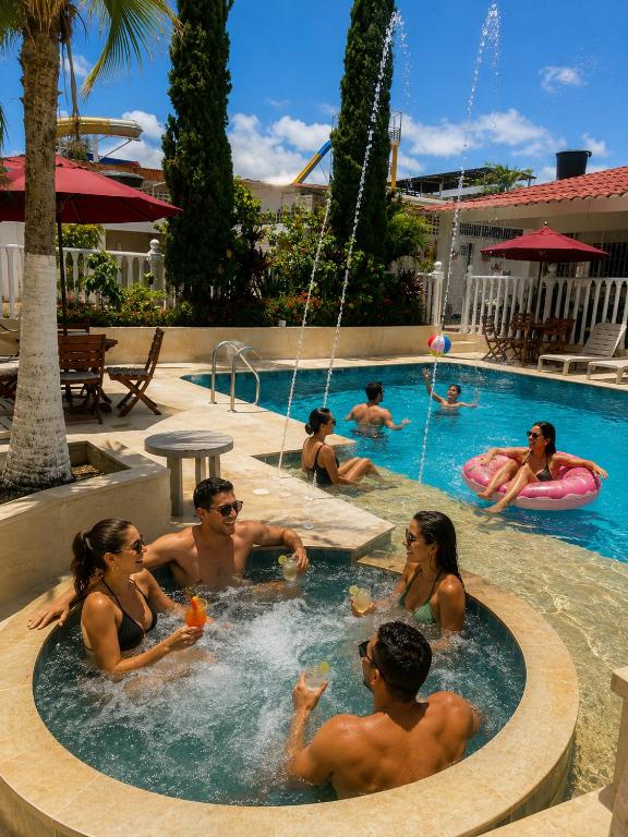 a group of people in a swimming pool at HOTEL MACEO MELGAR in Melgar