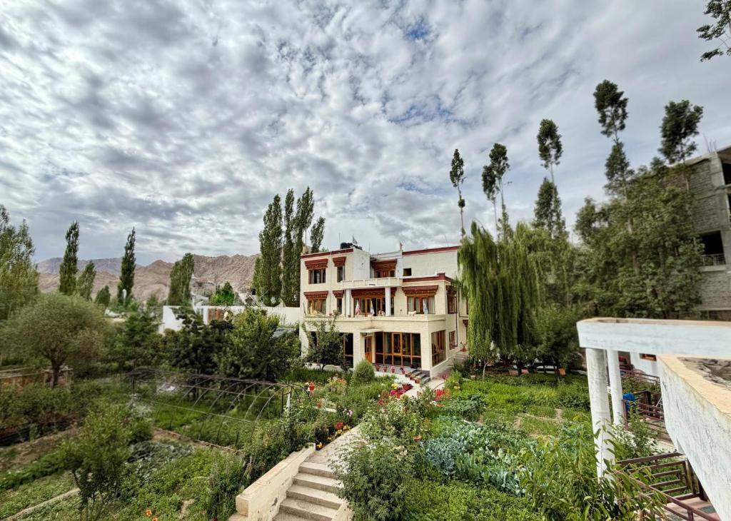 a large house with a garden in front of it at Niri-la Ladakh Leh in Leh