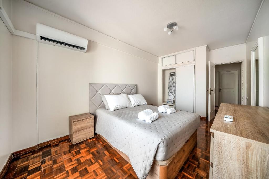 a bedroom with a bed with two pillows on it at HolidaysPT - Luanda - 2 Bedroom Apartment in Olhão