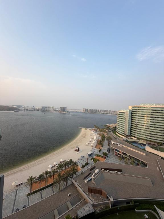 a view of a beach with a hotel and a resort at Marina private see view room in Abu Dhabi