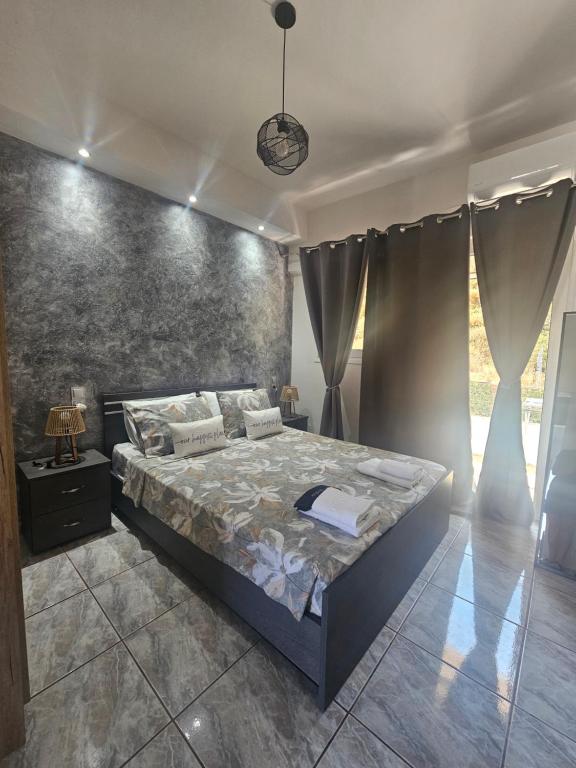 a bedroom with a bed and a wall at Alma-Libre house 2 in Kefalos