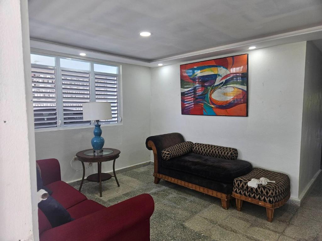 a living room with a couch and a chair at Spacious Beachfront Escape at Playa Guayanes for Large Groups in Yabucoa