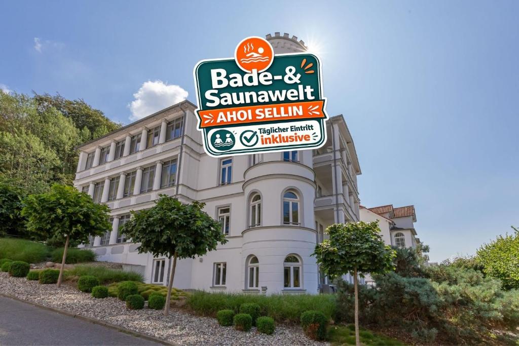 a building with a sign in front of it at Villa Odin, Muschelsucher - Bade- & Saunawelt täglich inklusive in Ostseebad Sellin