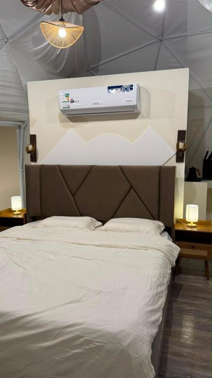 a bedroom with a bed with aperature at سكون in Al Baha