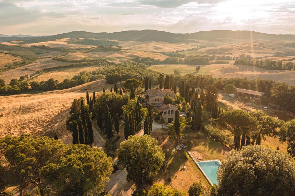 an aerial view of a villa in the hills with a pool at Agriturismo Quarantallina in Buonconvento