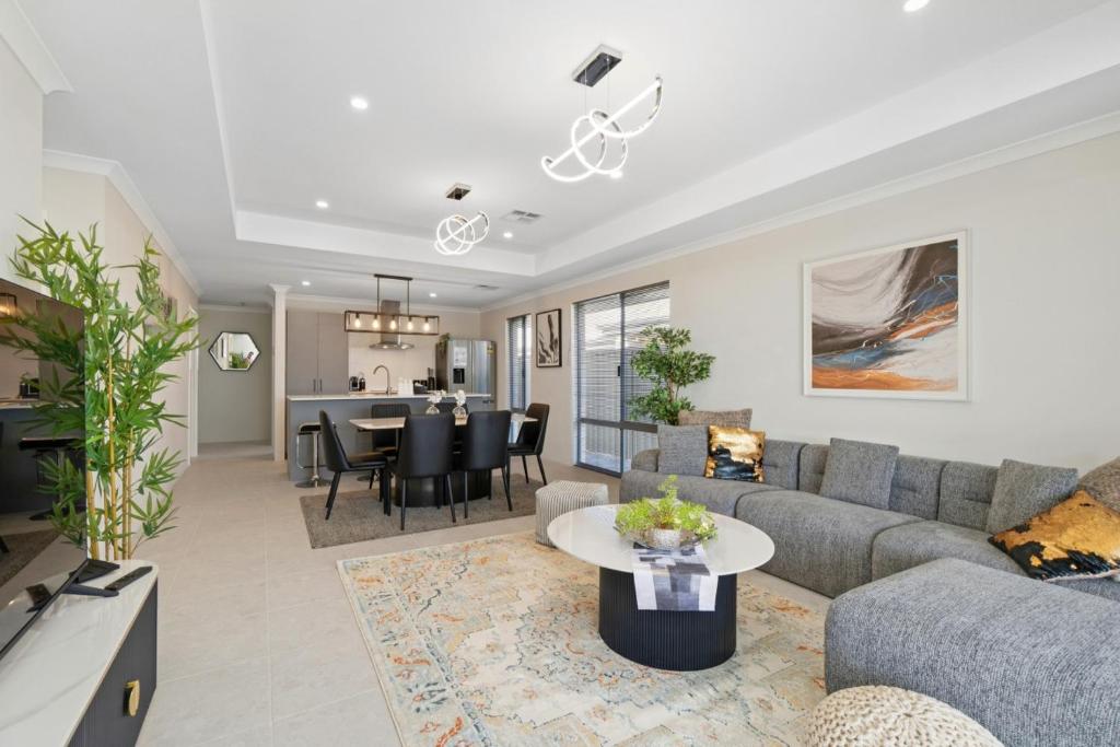 a living room with a couch and a table at Drift at Shorehaven Coast in Alkimos