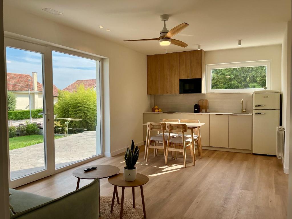 a kitchen and living room with a table and chairs at Quinta del Mar suites - Costa Quebrada in Soto de la Marina