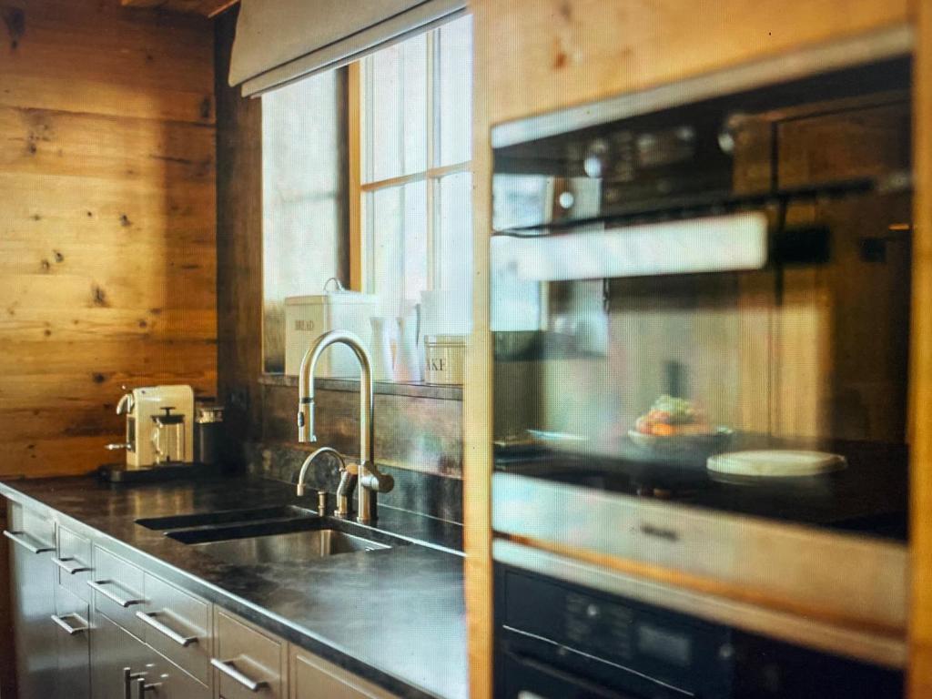a kitchen with a sink and a stove top oven at Valley View Residence in Sankt Anton am Arlberg
