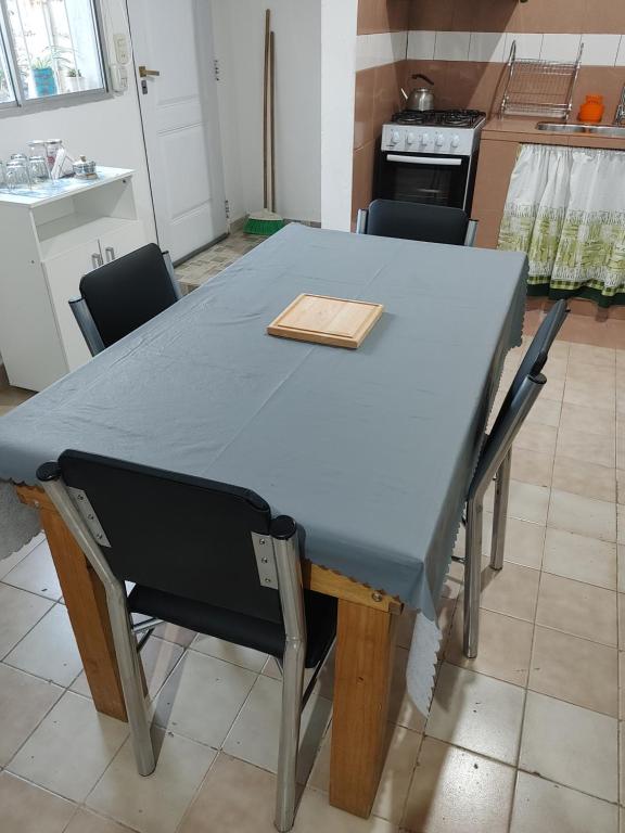 a blue table in a kitchen with chairs around it at Alquiler Ramos in Viedma