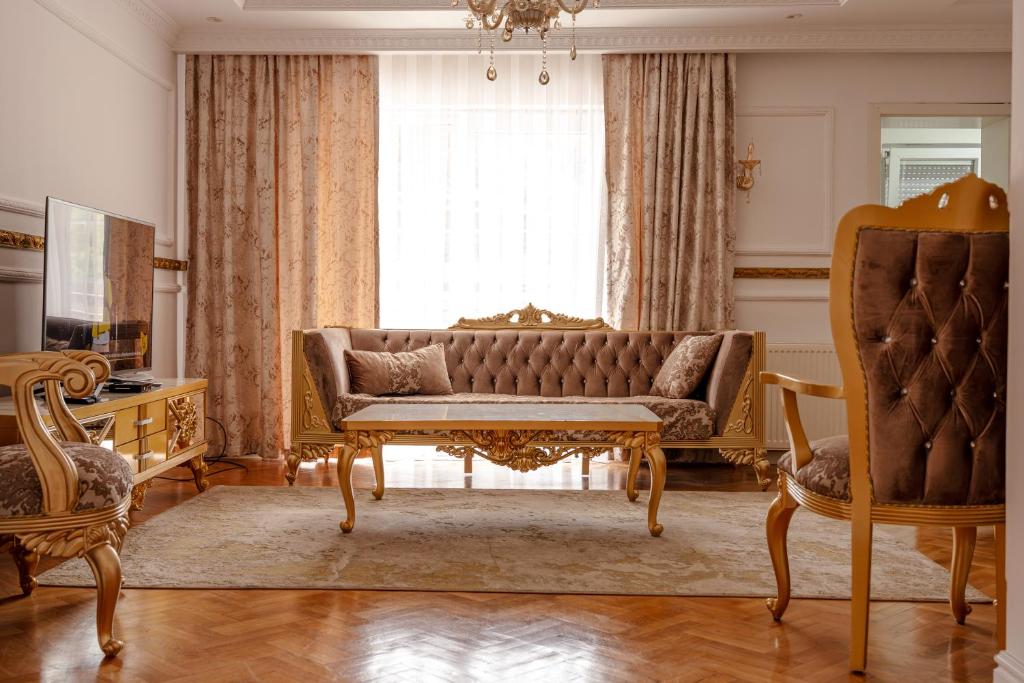 a living room with a couch and a window at Lux Stays in Prishtinë