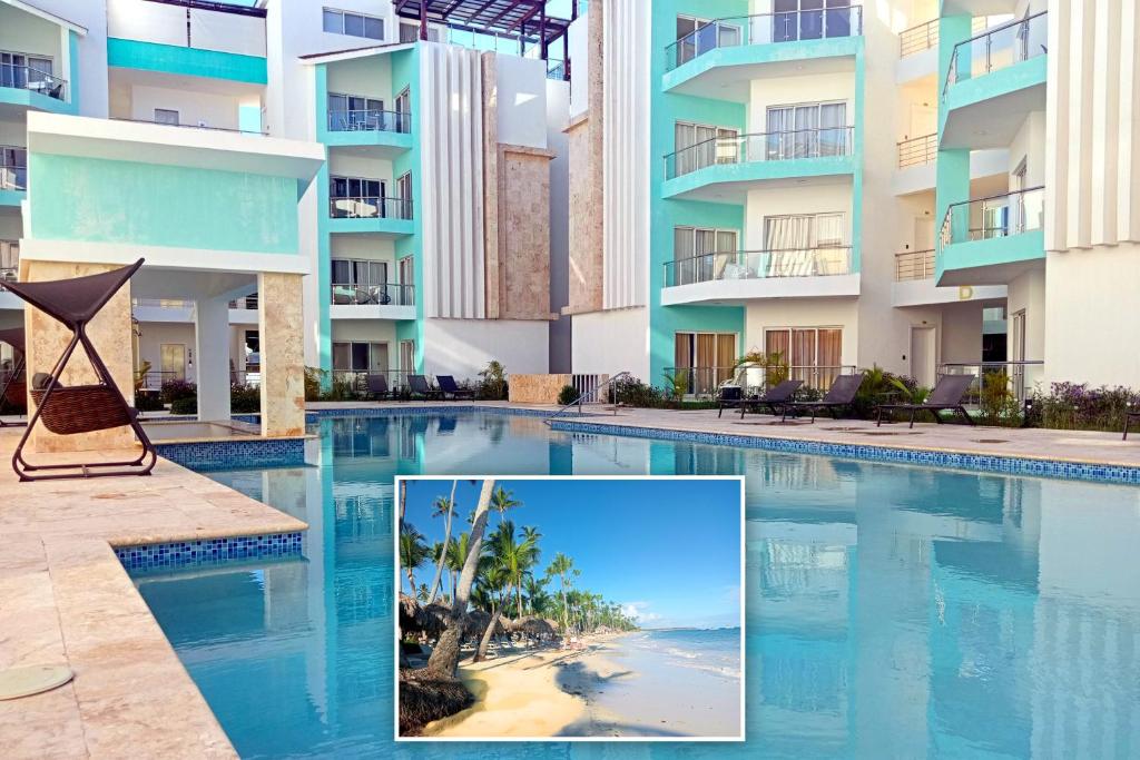 a hotel swimming pool with a picture of the beach at Maple Beach Residences Punta Cana in Punta Cana
