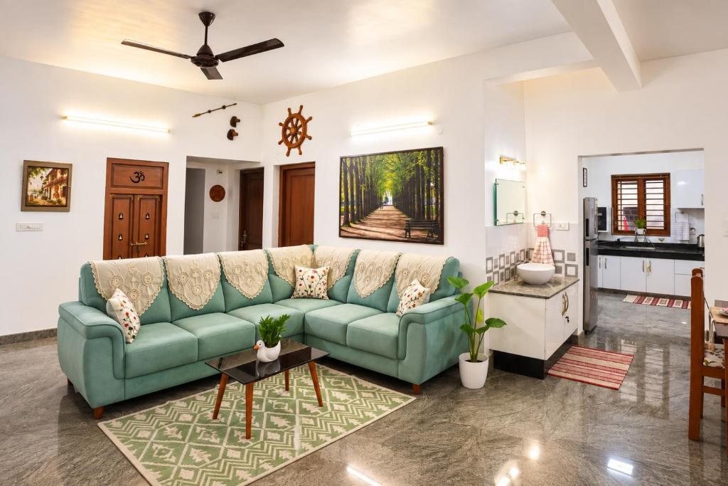 a living room with a couch and a table at Hridyas in Ernakulam