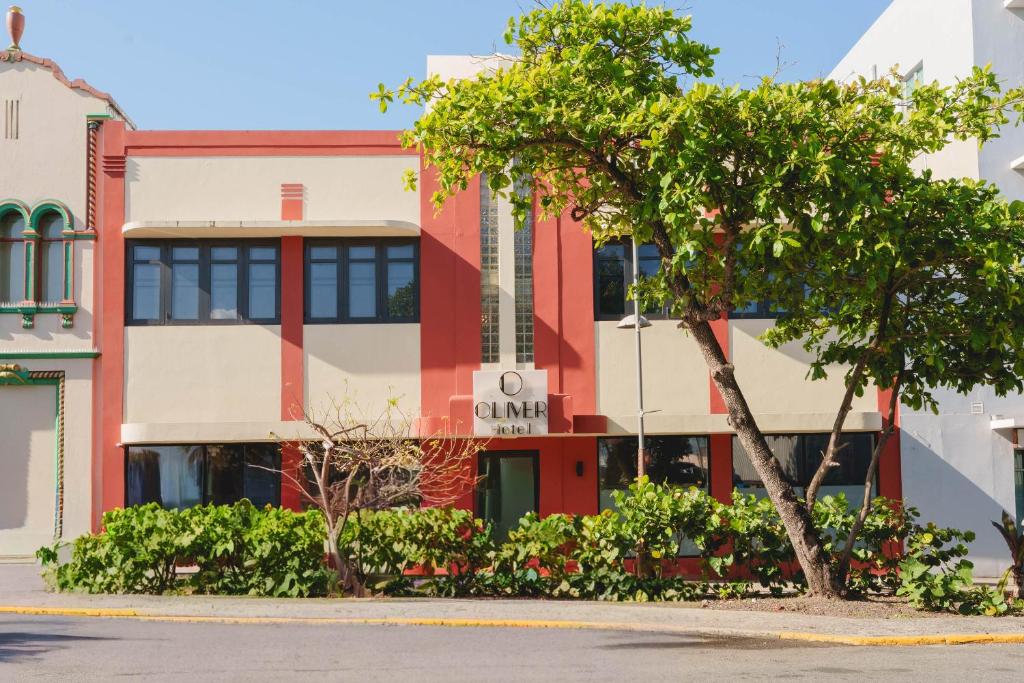 a building with a tree in front of a street at The Oliver Hotel - Adults Only in San Juan