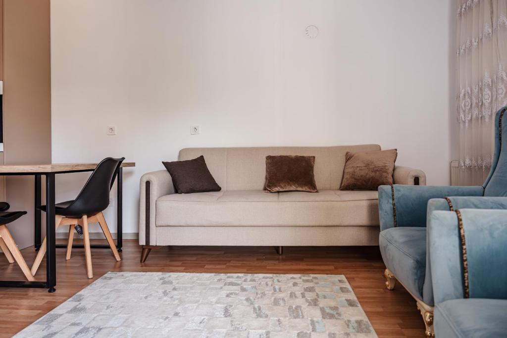 a living room with a couch and a table at Lux Stays in Prishtinë
