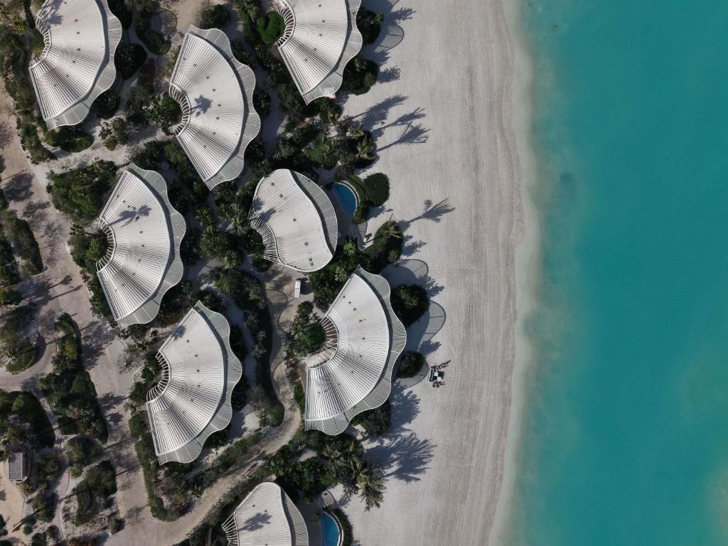 an overhead view of a group of buildings on the beach at SLS The Red Sea in Ḩanak