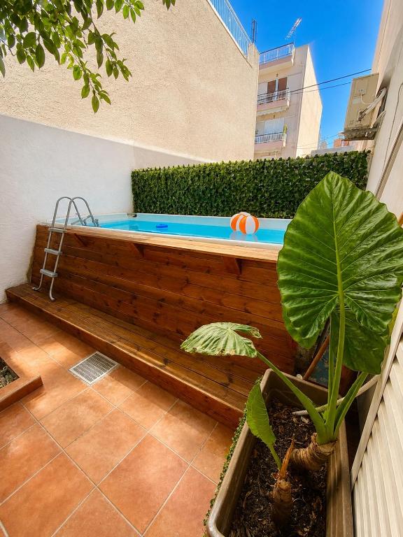 a hot tub in a backyard with a plant at Oasis Pool Flat-near 2 metro stations- in Piraeus